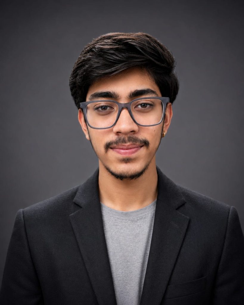 Professional headshot of the founder of Databyte, a leading digital marketing expert, wearing a black blazer and glasses against a dark grey background.